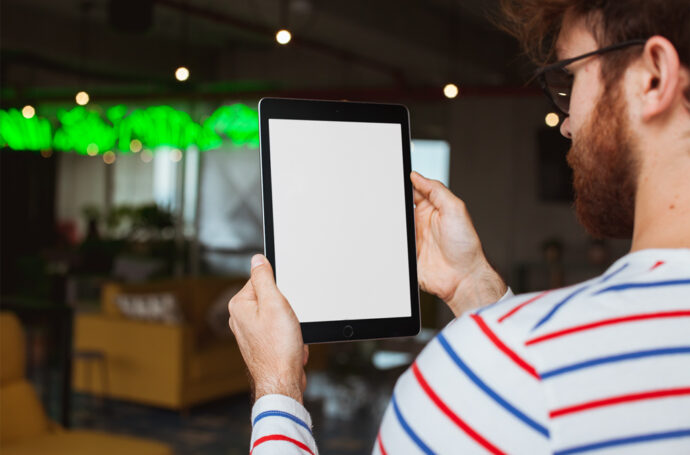 Generate a Restaurant Mockup with a Man Using an iPad