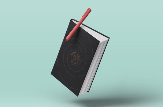 Mockup of a Hardcover Book Floating with Pen