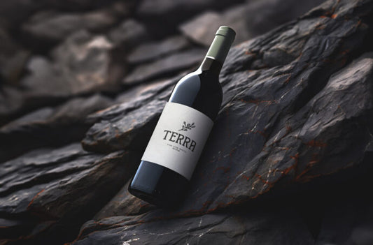 Mockup of a Red Wine Bottle Placed on a Rock for Display