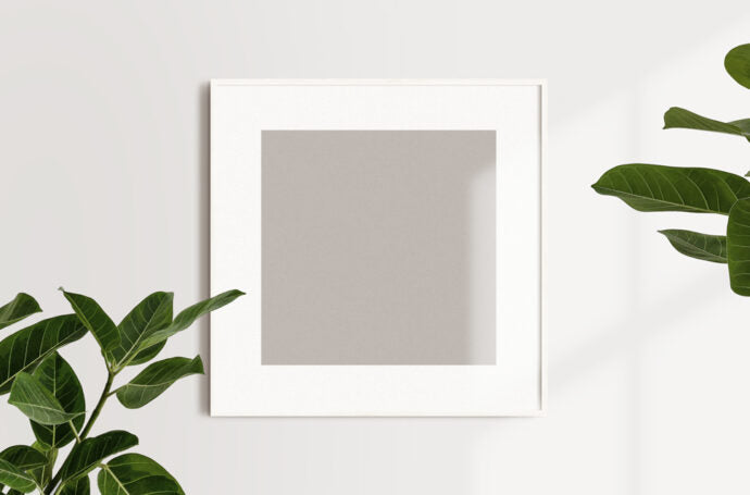 Mockup of a Square Photo Frame Hanging on a Wall